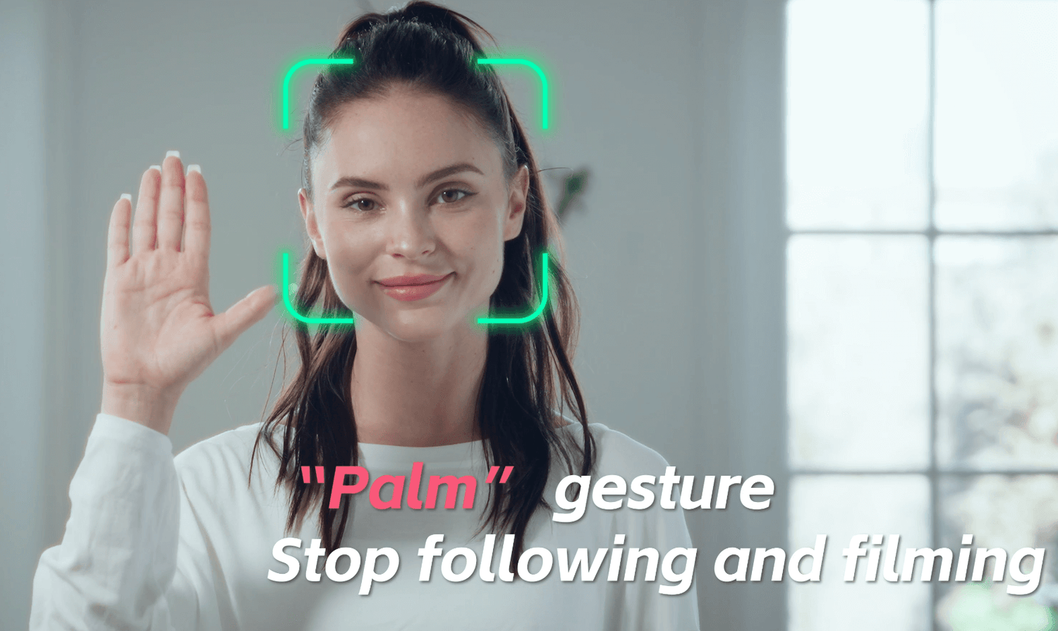 Woman demonstrating "Palm" gesture for stopping filming with AI technology.